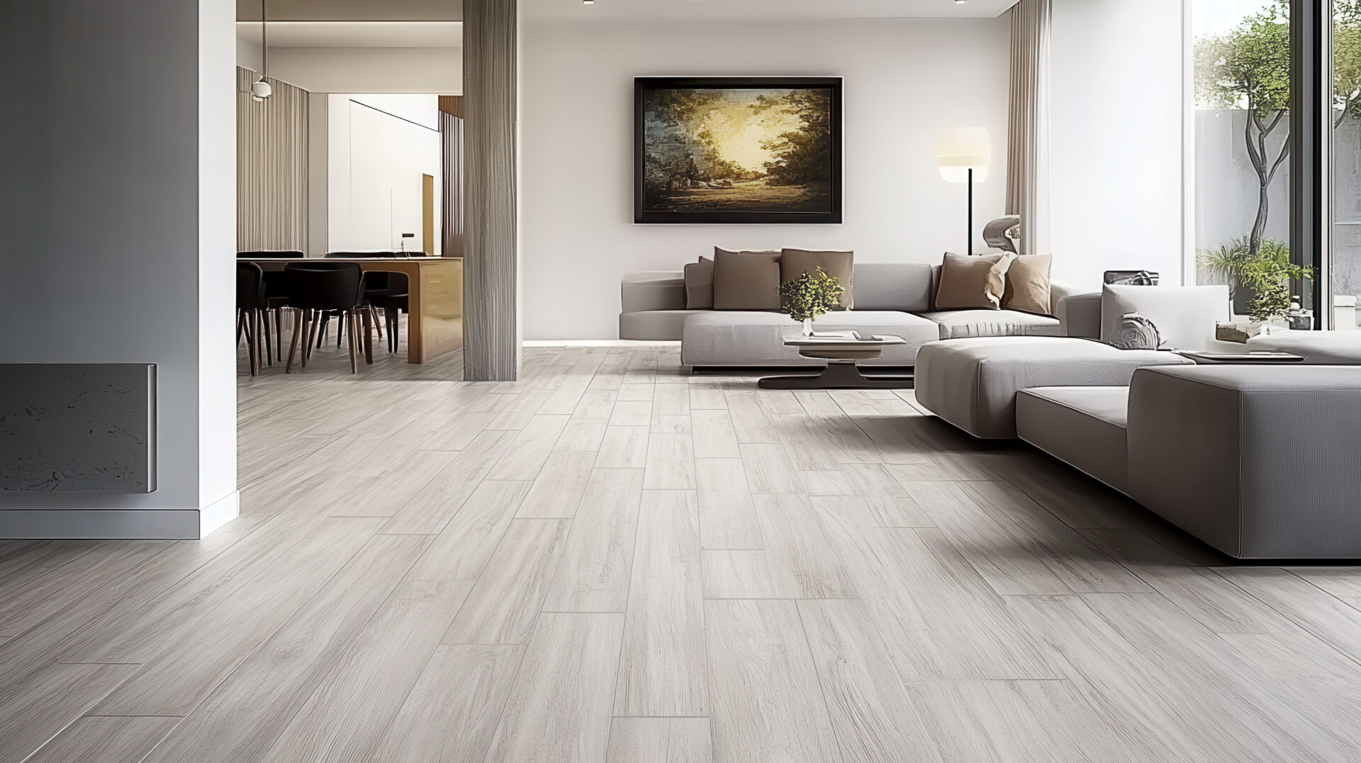 Modern open-concept living room featuring light wood-look tile flooring and minimalist grey furniture.